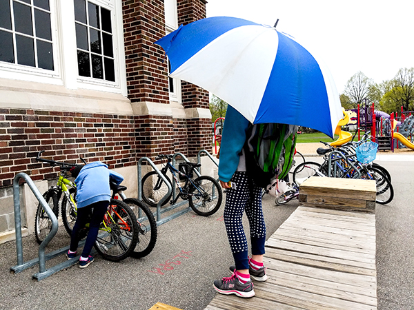 Picture of children locking their bikes up at a bike rack